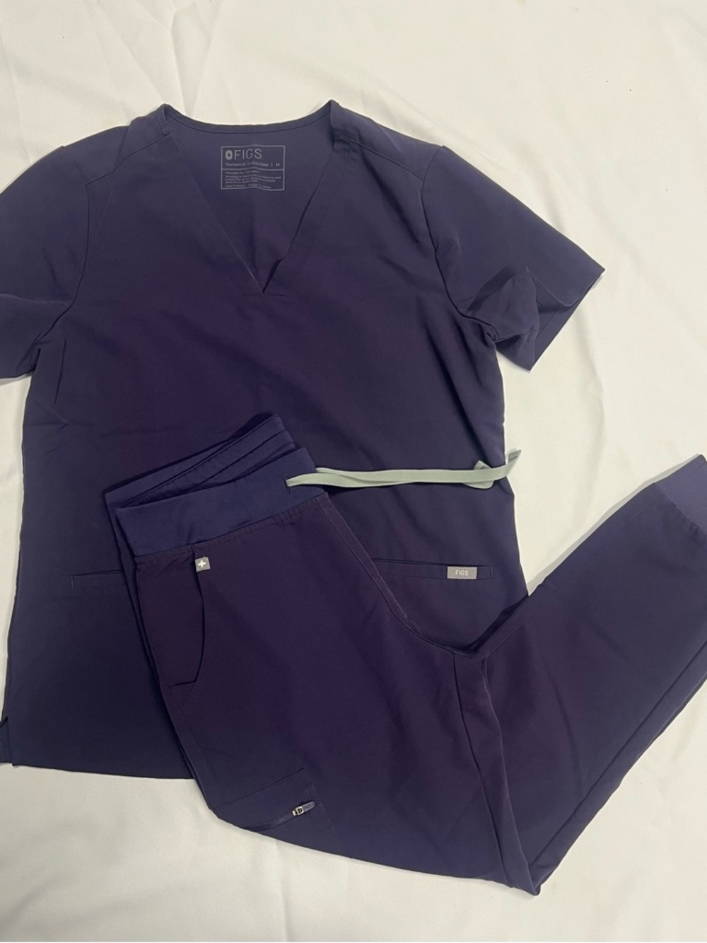 FIGS scrubs in purple shadow